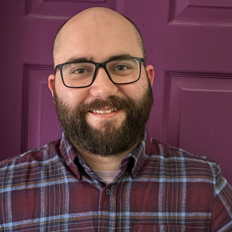 Jo Walkland, smiling in front of a purple door